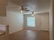 Neutral-toned living room featuring wood-look flooring, two ceiling fans, and ample natural light at 6177 Chesham Dr # 6, New Port Richey, FL 34653