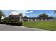 Community pool surrounded by lush green grass and a black metal fence at 6177 Chesham Dr # 6, New Port Richey, FL 34653