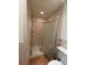 Enclosed shower with a light colored tiled surround and a glass door at 6177 Chesham Dr # 6, New Port Richey, FL 34653