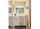 Modern bathroom with double vanity, bright lighting, and a large mirror at 727 83Rd N Ave # 101, St Petersburg, FL 33702