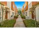 Attractive townhome exteriors featuring neutral paint, wood accents, landscaping, and a peaceful walkway at 855 3Rd N Ave, St Petersburg, FL 33701