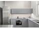 Modern kitchen features gray cabinets, stainless steel appliances, and sleek countertops at 855 3Rd N Ave, St Petersburg, FL 33701