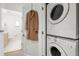 Convenient laundry area featuring a stacked washer and dryer, with a view into the adjacent bathroom at 855 3Rd N Ave, St Petersburg, FL 33701
