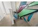 Carpeted stairwell with custom graffiti art along the block wall at 855 3Rd N Ave, St Petersburg, FL 33701