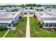 Aerial view of condo community with walkway and green space between buildings at 201 Bedford St # 79, Sun City Center, FL 33573