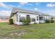 Rear view of a single-story home with screened porch at 201 Bedford St # 79, Sun City Center, FL 33573