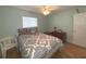 Bedroom with light walls and wood floors at 215 Valencia Blvd # 105, Belleair Bluffs, FL 33770