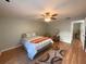 Bright bedroom with wood floors and ceiling fan at 215 Valencia Blvd # 105, Belleair Bluffs, FL 33770