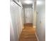Hallway with light walls, wood floors, and built-in closets at 215 Valencia Blvd # 105, Belleair Bluffs, FL 33770