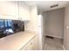 Bright kitchen features ample counter space and white cabinetry at 215 Valencia Blvd # 105, Belleair Bluffs, FL 33770