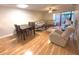 Bright living room features hardwood floors, comfy seating, and a dining area at 215 Valencia Blvd # 105, Belleair Bluffs, FL 33770