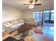 Spacious living room with hardwood floors, comfy seating, and access to patio at 215 Valencia Blvd # 105, Belleair Bluffs, FL 33770