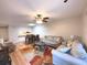Living room with hardwood floors, ample seating, and adjacent dining area at 215 Valencia Blvd # 105, Belleair Bluffs, FL 33770