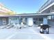 Community pool area with seating and grilling station at 215 Valencia Blvd # 105, Belleair Bluffs, FL 33770
