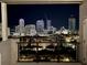 Balcony view of the city at night, featuring lit buildings against the dark sky at 226 5Th N Ave # 1502, St Petersburg, FL 33701