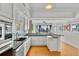 Bright kitchen with stainless appliances, black counters and a breakfast bar looking into the living room at 226 5Th N Ave # 1502, St Petersburg, FL 33701