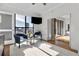 Cozy living room with a view of the city through expansive windows and access to the balcony at 226 5Th N Ave # 1502, St Petersburg, FL 33701