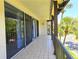 Covered balcony with tiled flooring, offering serene views and access to the outdoors through sliding glass doors at 3031 Countryside Blvd # 35C, Clearwater, FL 33761