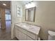 Bathroom featuring vanity with marble countertop, chrome fixtures, and framed mirror at 3031 Countryside Blvd # 35C, Clearwater, FL 33761