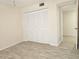 This bright bedroom features wood-look floors, a large closet, and a neutral color palette at 3031 Countryside Blvd # 35C, Clearwater, FL 33761