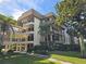 Exterior view of a multi-story building with balconies and mature landscaping at 3031 Countryside Blvd # 35C, Clearwater, FL 33761
