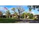 Beautiful clubhouse exterior showcasing manicured lawns, mature trees, and an American flag for community pride at 3031 Countryside Blvd # 35C, Clearwater, FL 33761