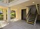 Building access with staircase, elevator, and manicured landscaping at 3031 Countryside Blvd # 35C, Clearwater, FL 33761