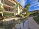 Beautiful exterior view of building with lush landscaping, waterfall features, and well-maintained grounds at 3031 Countryside Blvd # 35C, Clearwater, FL 33761