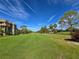 Expansive golf course view featuring manicured lawns, tall palm trees, and a clear blue sky for a serene backdrop at 3031 Countryside Blvd # 35C, Clearwater, FL 33761