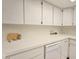 Bright kitchen featuring white countertops, cabinets, and modern appliances at 3031 Countryside Blvd # 35C, Clearwater, FL 33761