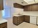 Kitchen showcasing wood cabinets and view into the living area at 3031 Countryside Blvd # 35C, Clearwater, FL 33761