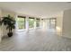 Bright living room with tile floors and access to balcony with floor to ceiling sliding doors and large potted plant at 3031 Countryside Blvd # 35C, Clearwater, FL 33761