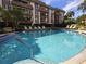Community pool with lounge chairs available at 3031 Countryside Blvd # 35C, Clearwater, FL 33761