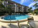 Community pool with lounge chairs available at 3031 Countryside Blvd # 35C, Clearwater, FL 33761