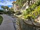 Outdoor water feature with lush landscaping surrounding a walkway at the property at 3031 Countryside Blvd # 35C, Clearwater, FL 33761