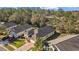 Overhead view of single-Gathering home with golf course and woods in the background of a quiet neighborhood at 4275 Caskie Pl, Brooksville, FL 34604
