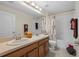 Well-lit bathroom with dual sinks, framed mirrors, and tub-shower combination at 4275 Caskie Pl, Brooksville, FL 34604
