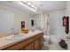 Well-lit bathroom featuring a dual sink vanity, and a shower and tub combination at 4275 Caskie Pl, Brooksville, FL 34604