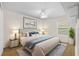 Well-lit bedroom featuring a queen bed, modern ceiling fan, and tasteful decor at 4275 Caskie Pl, Brooksville, FL 34604