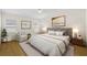 Bright bedroom featuring a neutral color palette, accent chair, and light wood floors at 4275 Caskie Pl, Brooksville, FL 34604