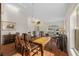 Bright dining room featuring a chandelier, hardwood floors, and large windows at 4275 Caskie Pl, Brooksville, FL 34604