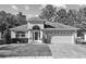 Charming single-story home featuring a two-car garage, manicured lawn, and covered front entry at 4275 Caskie Pl, Brooksville, FL 34604