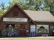 Rustic log cabin-style building housing Flippin' Out Vintage & Notions, a unique vintage shop at 4275 Caskie Pl, Brooksville, FL 34604