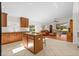 Spacious kitchen overlooking the Gathering room, with an island and tile flooring at 4275 Caskie Pl, Brooksville, FL 34604