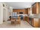 Well-lit kitchen with tile flooring, a center island with seating, and ample cabinet space at 4275 Caskie Pl, Brooksville, FL 34604