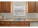 Well-maintained kitchen sink and counter area with natural light and ample storage cabinets at 4275 Caskie Pl, Brooksville, FL 34604
