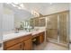 Bathroom featuring double sinks, a tile shower, and ample counter space at 4275 Caskie Pl, Brooksville, FL 34604