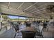 Spacious covered patio featuring ample seating and views of a golf course at 4275 Caskie Pl, Brooksville, FL 34604