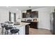 Modern kitchen featuring dark cabinetry and an island with seating at 4485 Sand Dollar Way, Zephyrhills, FL 33541