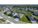 Beautiful aerial view of a well-manicured lawn and homes nestled around a pond at 9152 Warm Springs Cir, Parrish, FL 34219